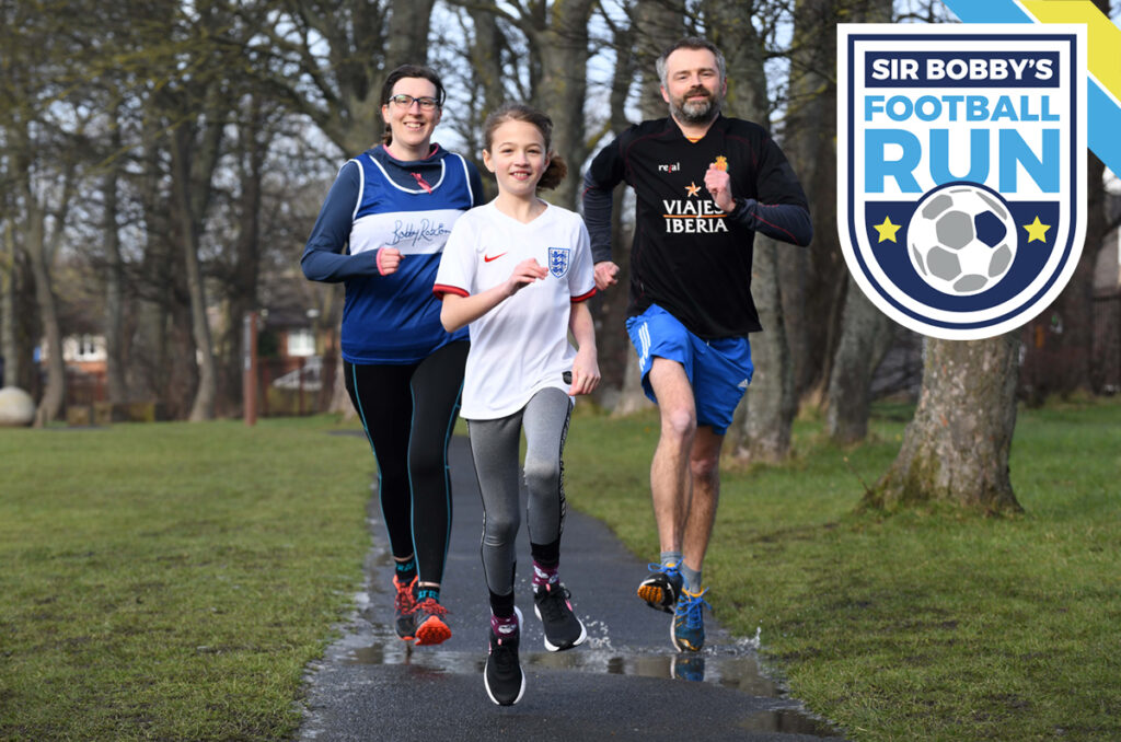 Woman, girl and Man running towards camera with the SIr Bobby's Football Run logo in the top right corner