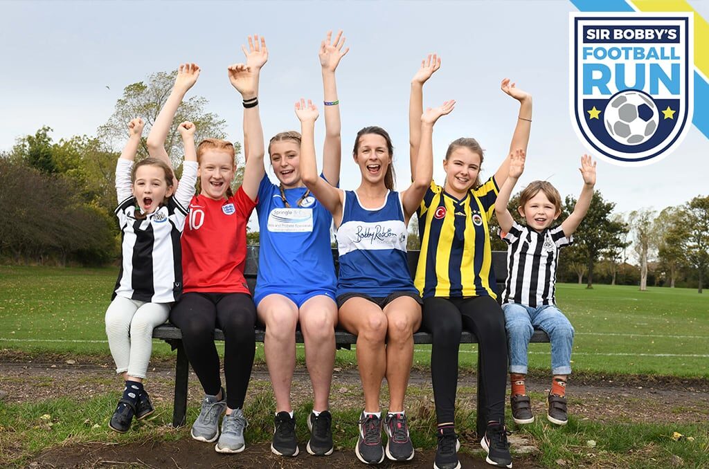 Group of runners on a bench waving arms in the air - Sir Bobbys Football Run logo in corner